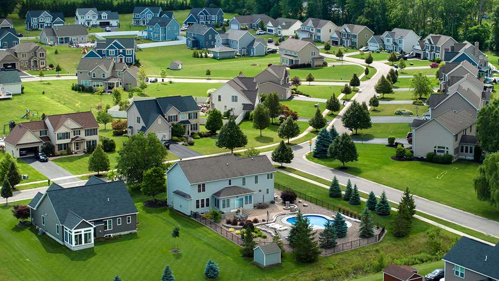 Upscale suburban private residential homes with large backyards and lush grassy lawns